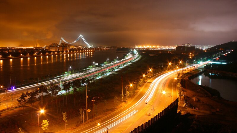 Nighttime Cityscape with Bridge — Orange