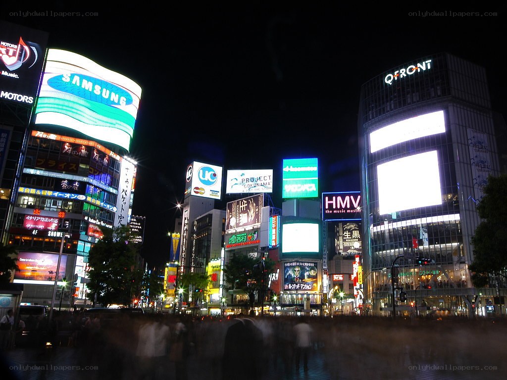 Nighttime cityscape with bright billboards