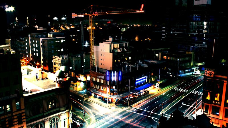 Nighttime cityscape with crane