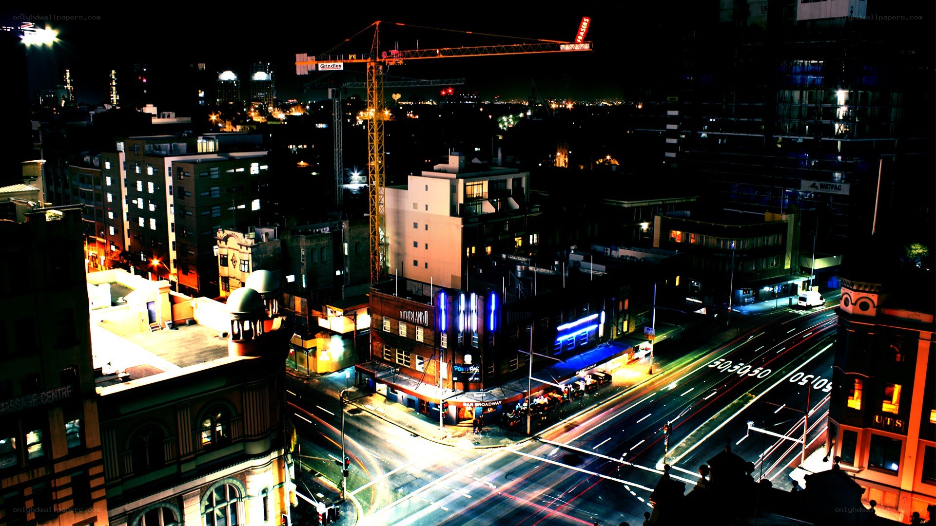 Nighttime cityscape with crane