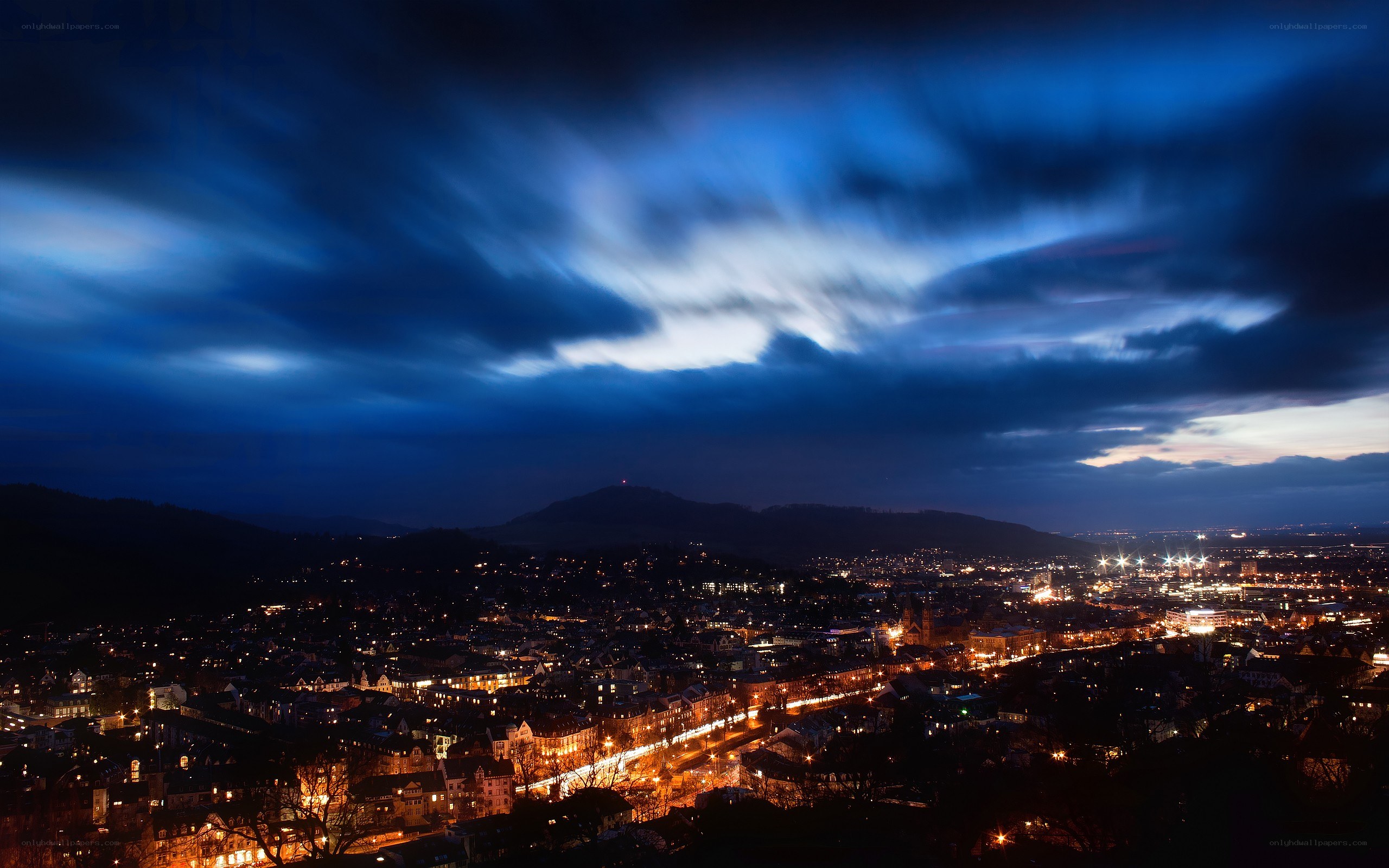 nighttime cityscape with dramatic sky
