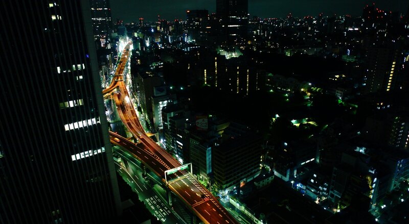 nighttime cityscape with elevated highway