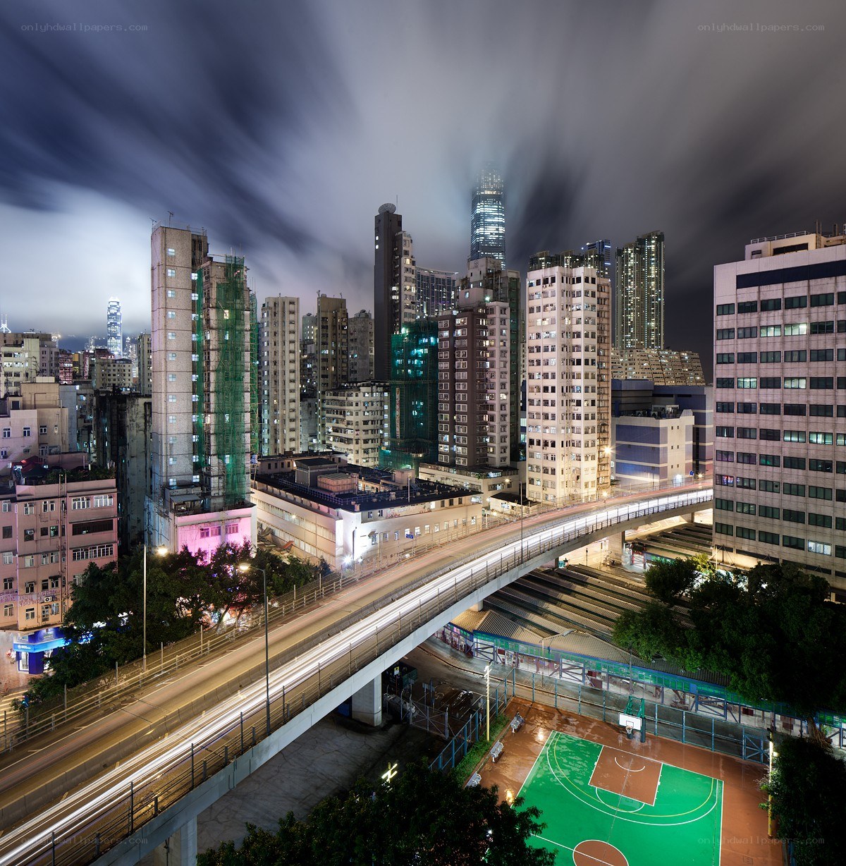 Nighttime cityscape with elevated highway