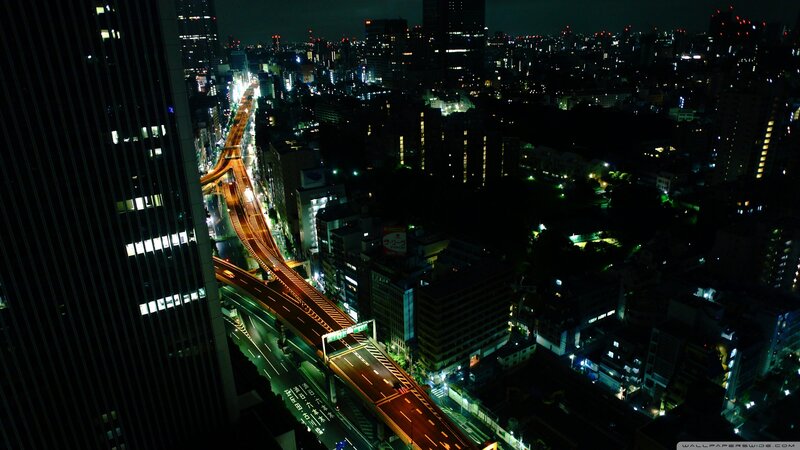 nighttime cityscape with elevated highway