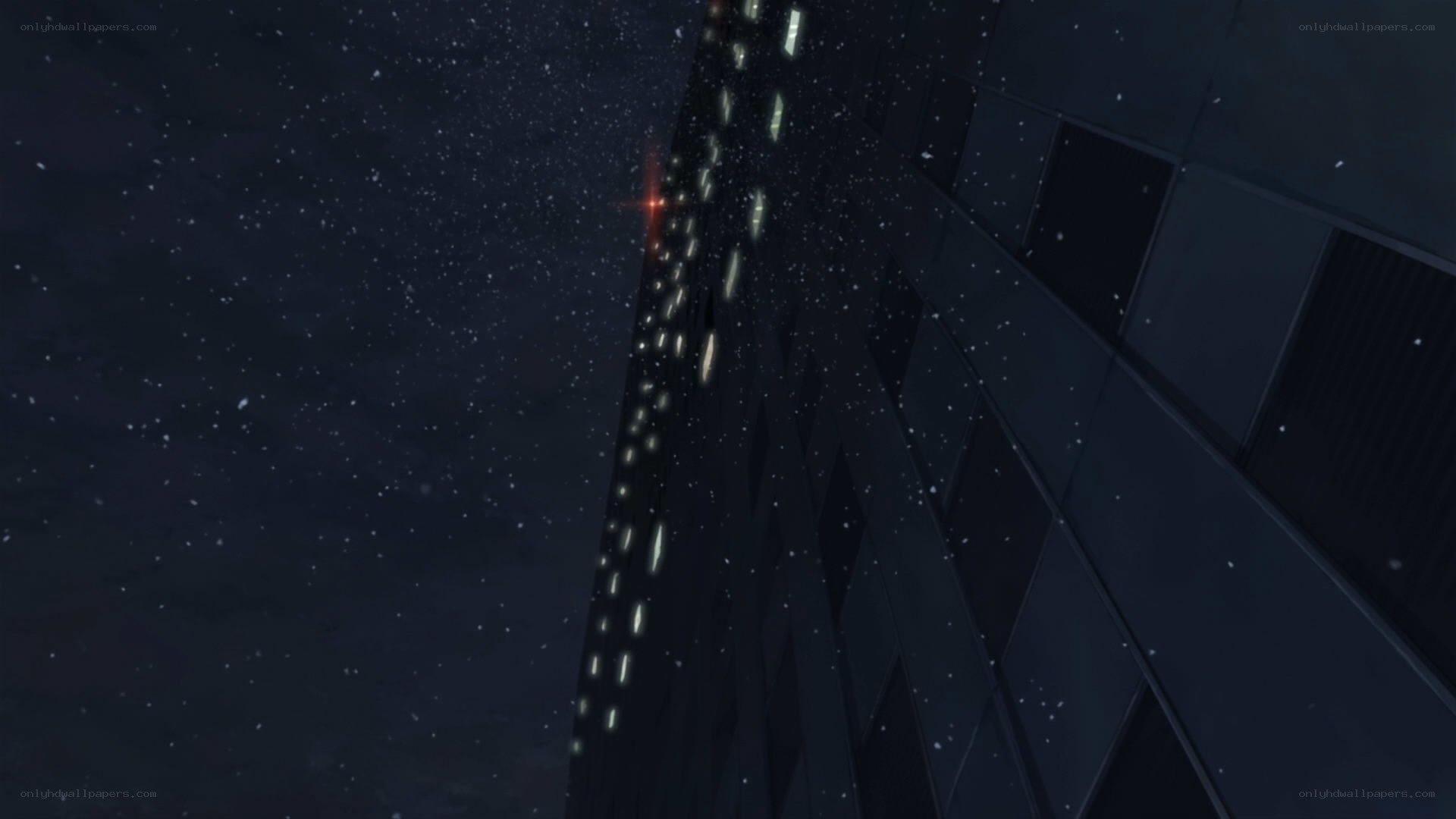 nighttime cityscape with falling snow