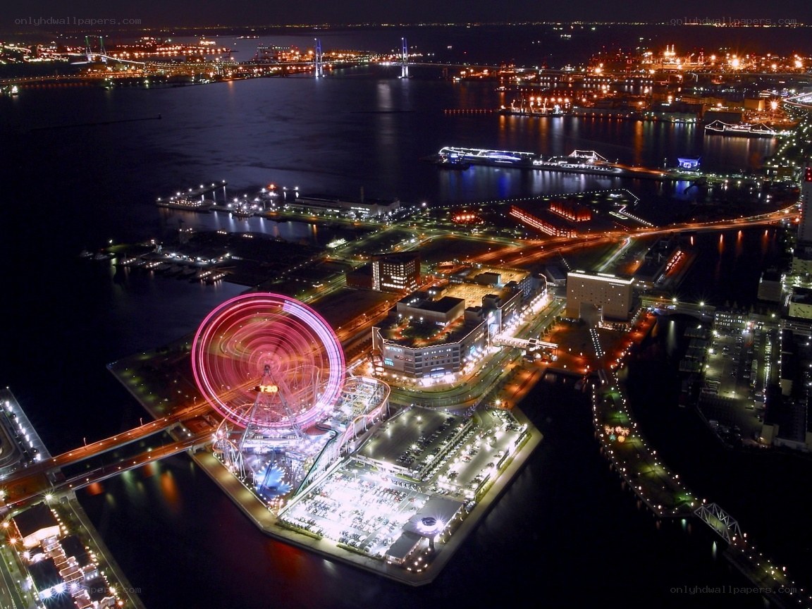 nighttime cityscape with ferris wheel