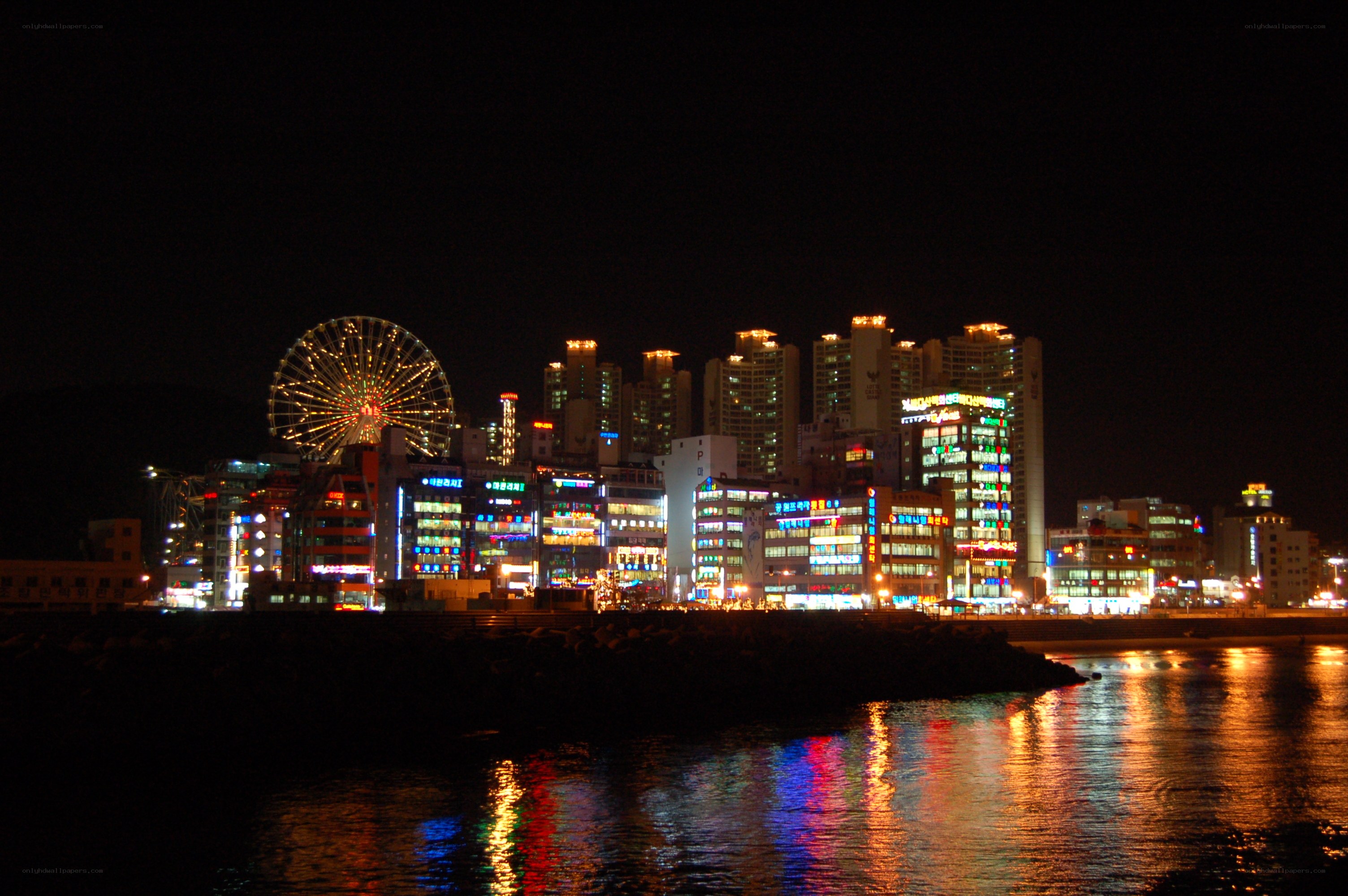 nighttime cityscape with ferris wheel