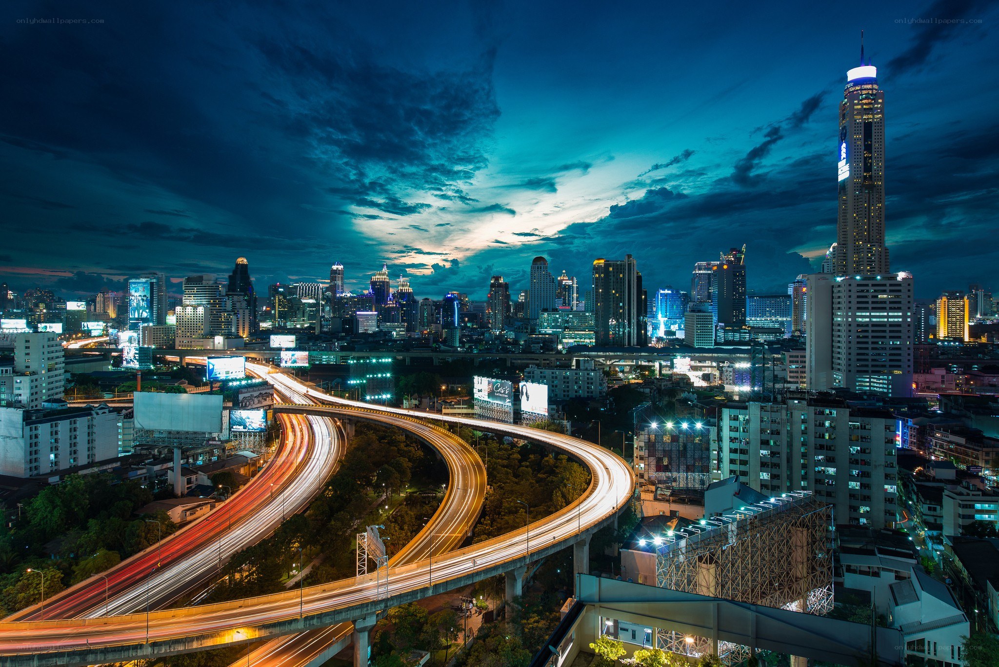 Nighttime cityscape with highway lights