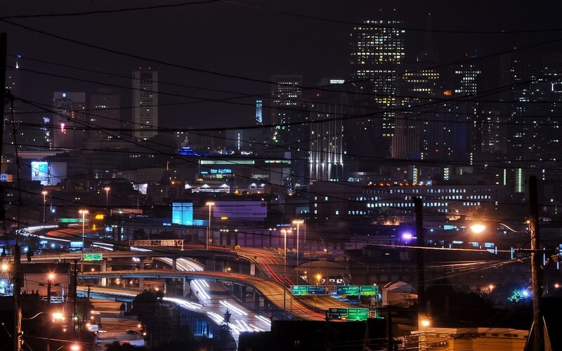 Nighttime cityscape with highways