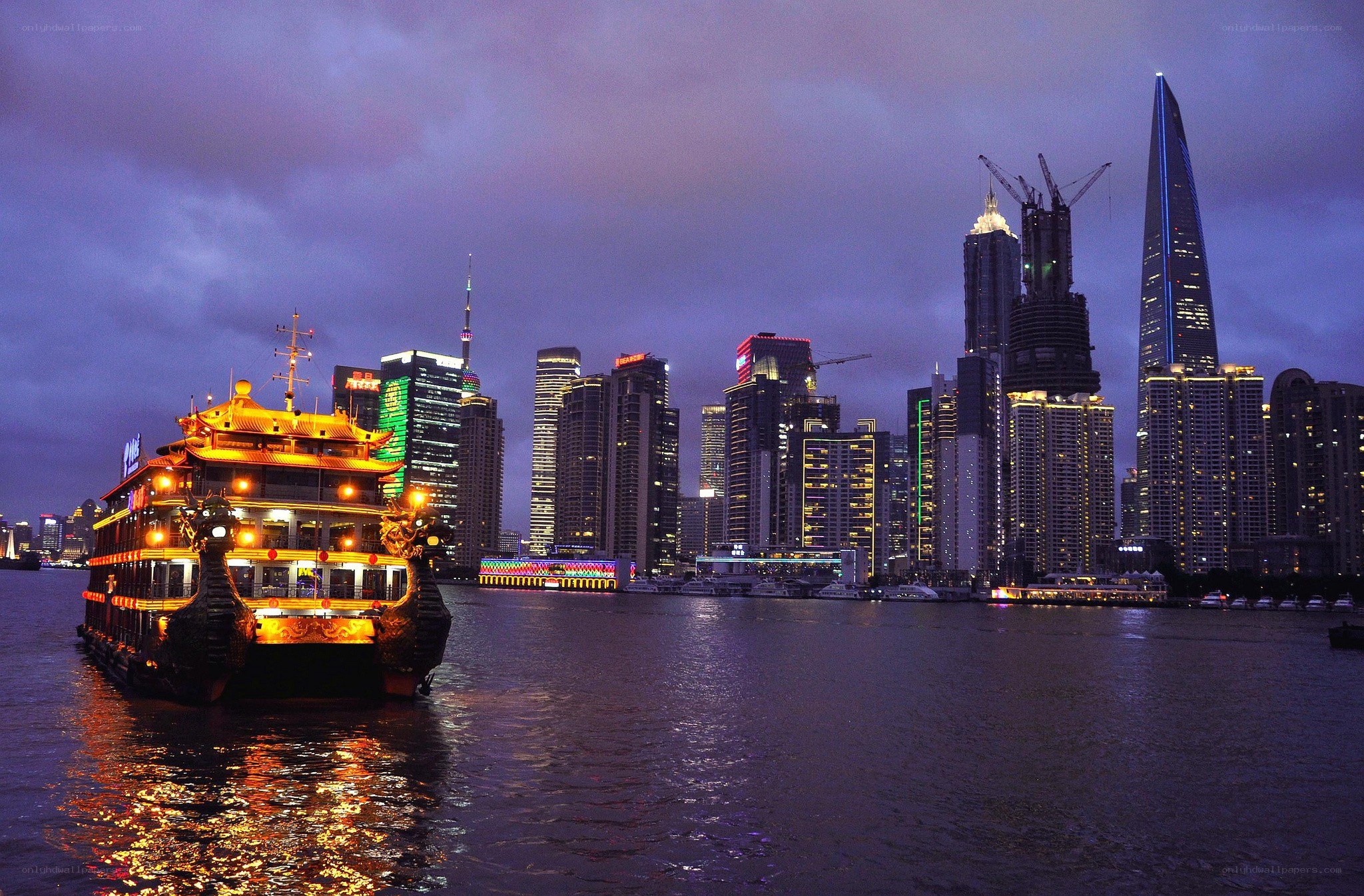 nighttime cityscape with illuminated boat