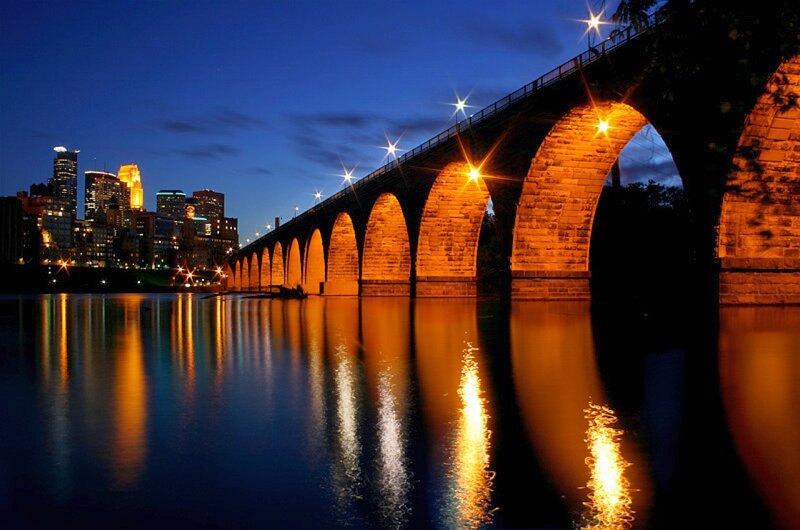 nighttime cityscape with illuminated bridge