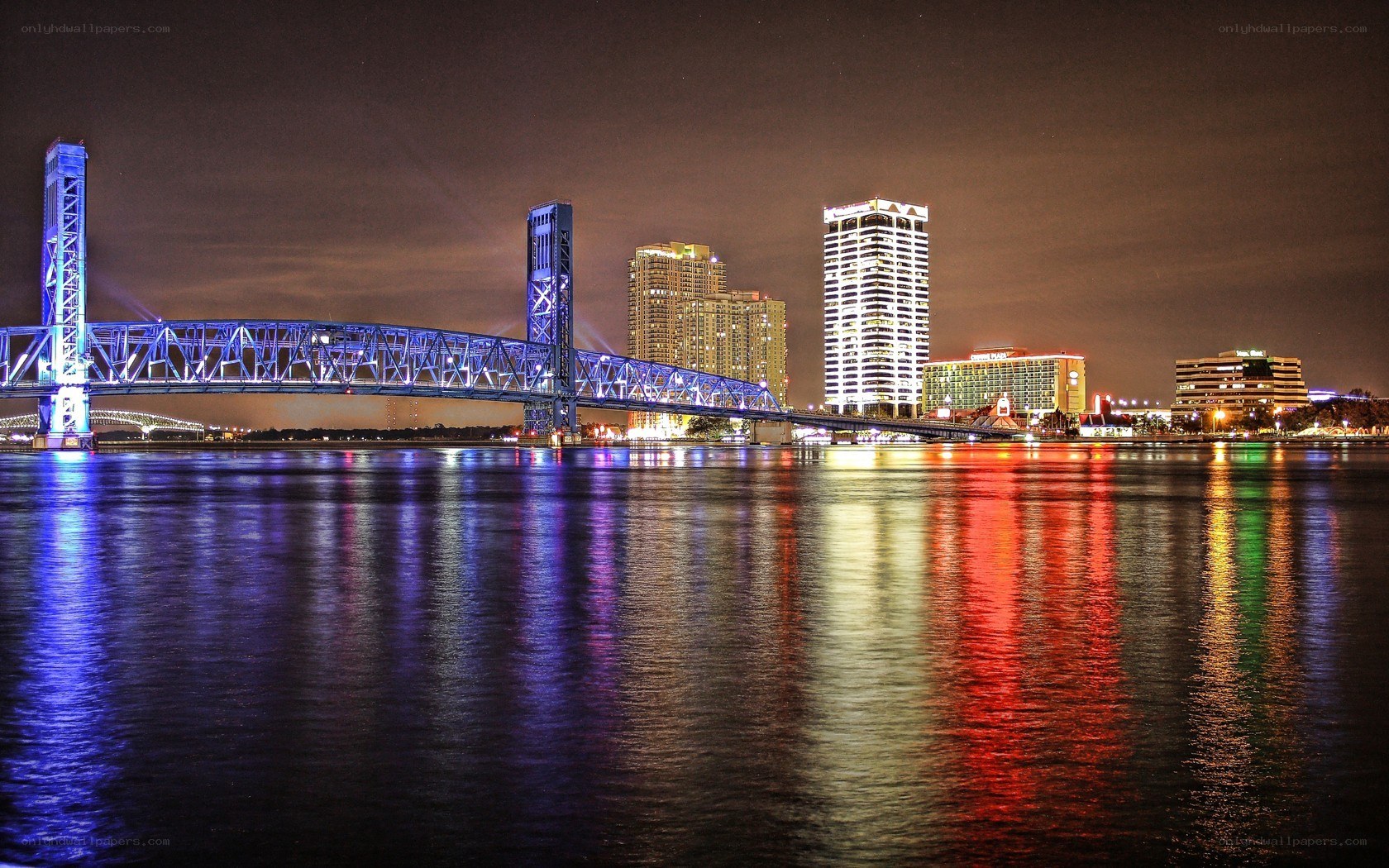 nighttime cityscape with illuminated bridge