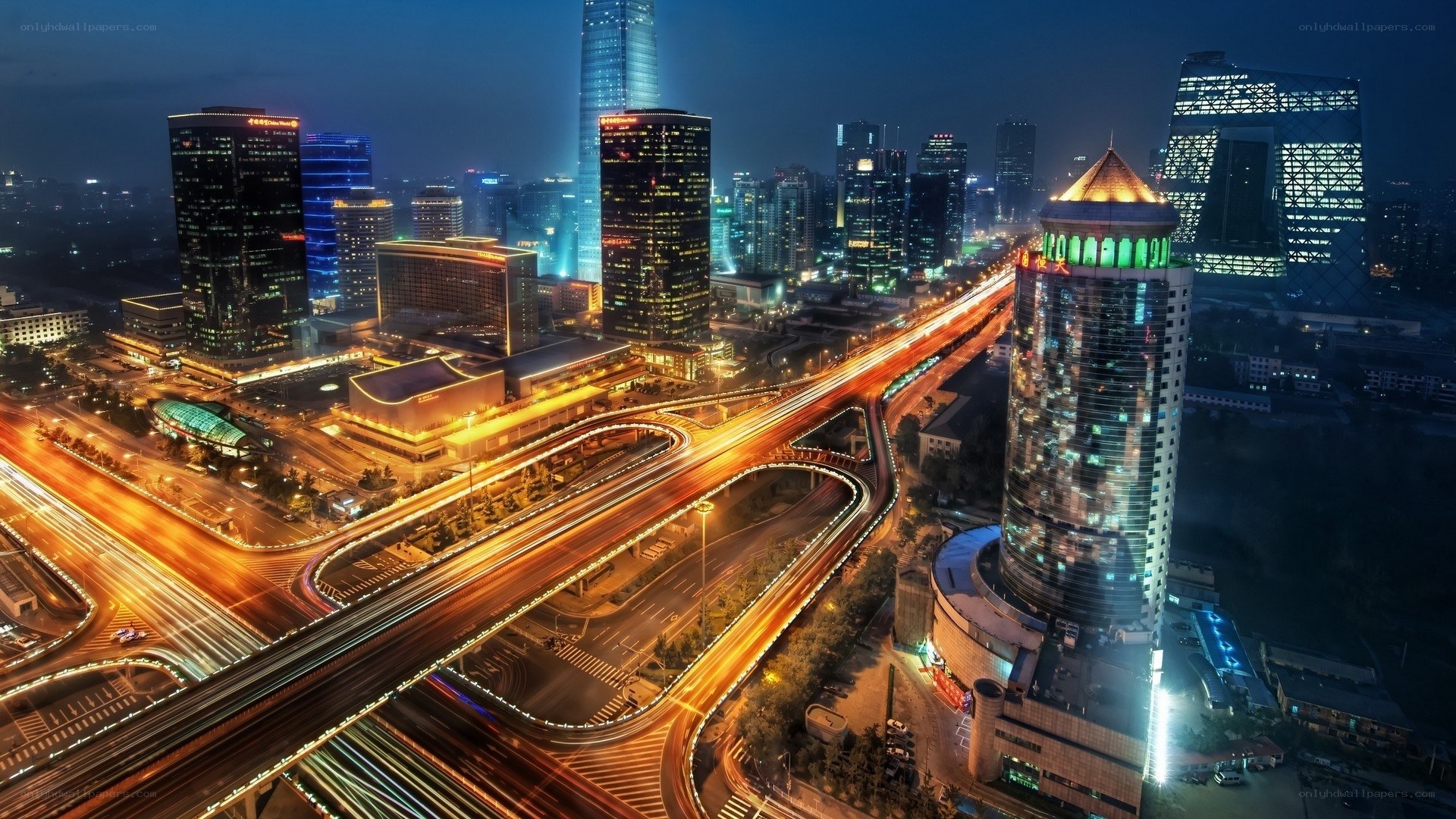 Nighttime cityscape with illuminated highways
