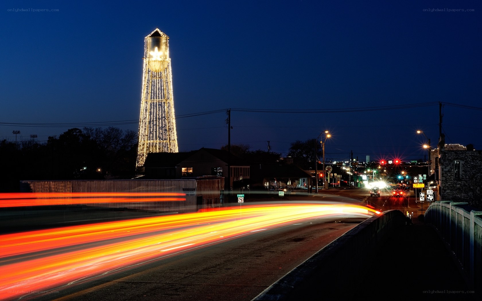 Nighttime cityscape with illuminated tower
