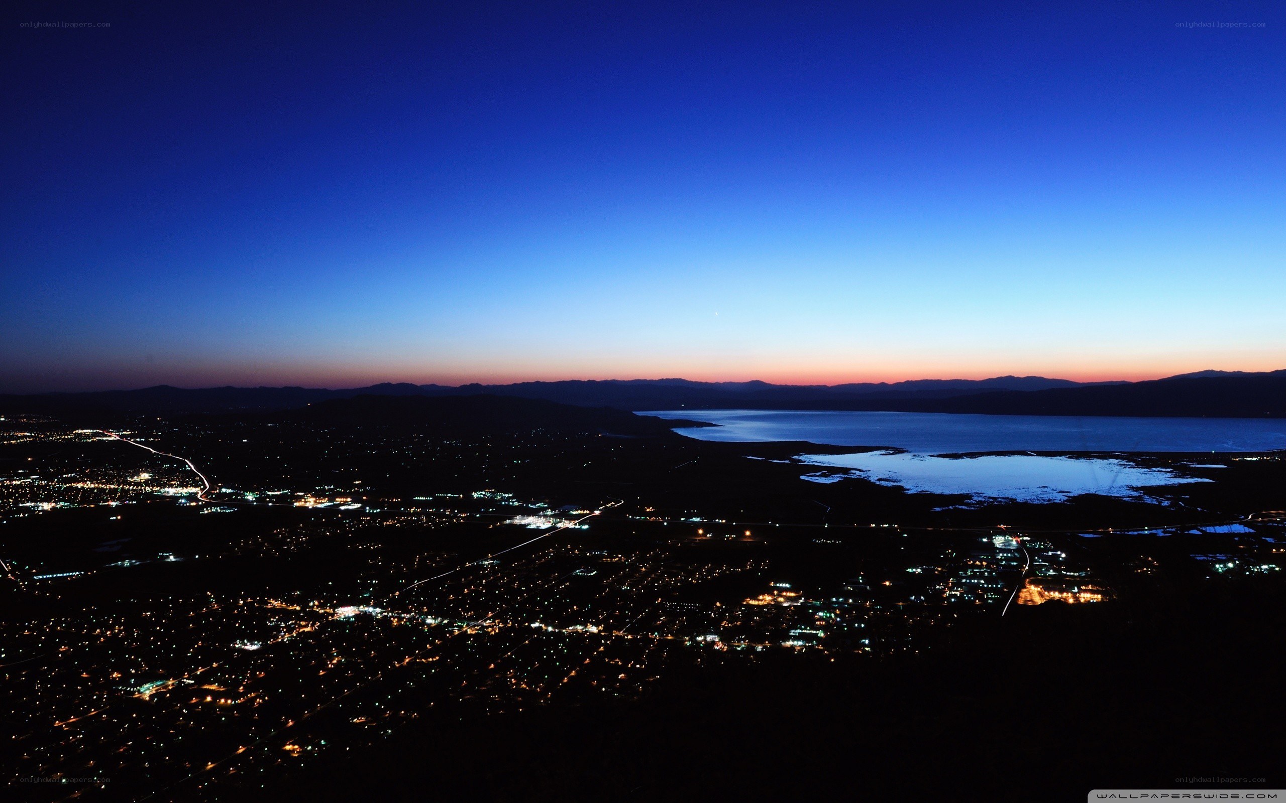 nighttime cityscape with lake