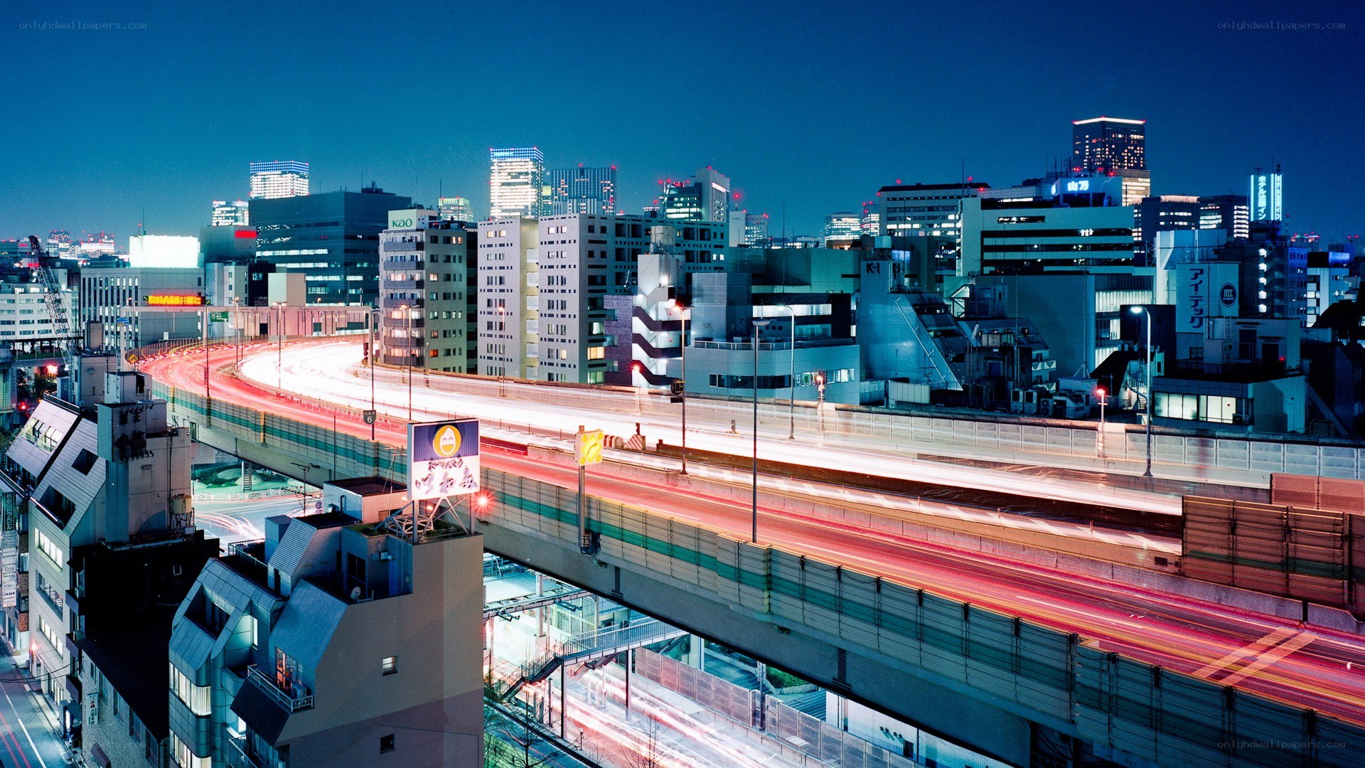 Nighttime cityscape with light trails