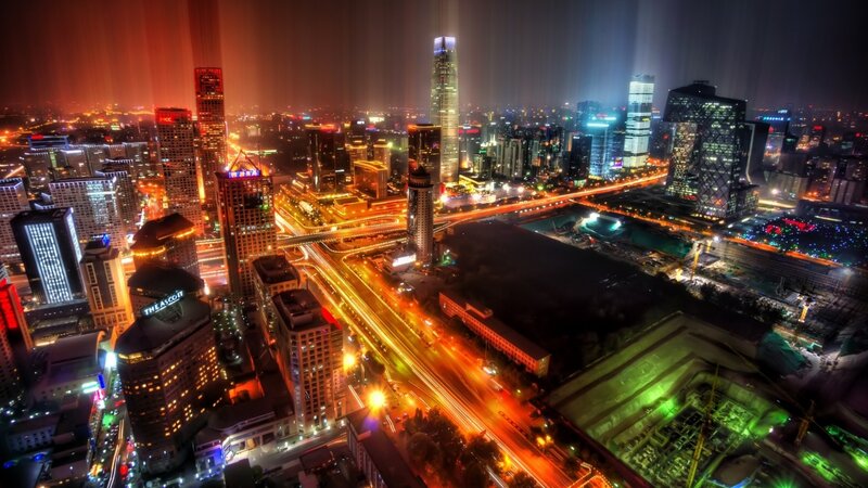nighttime cityscape with light trails