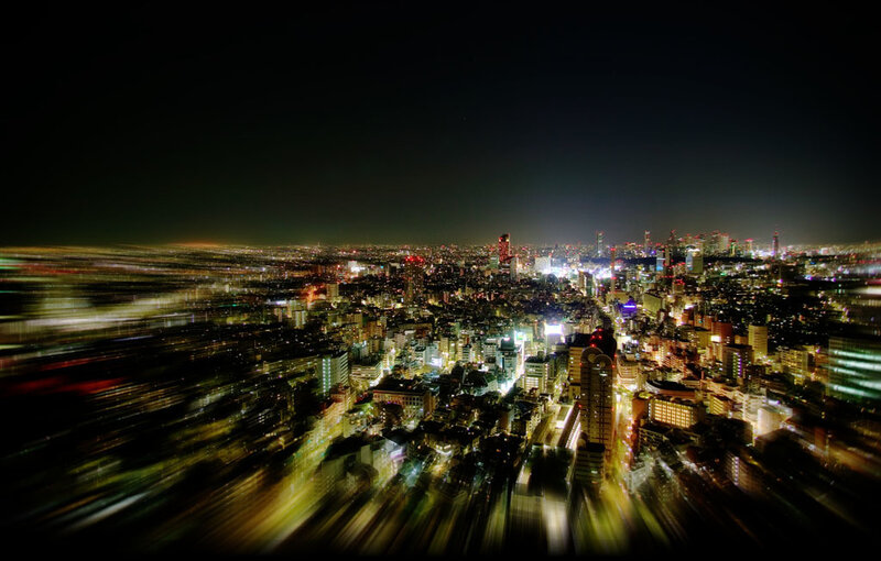 nighttime cityscape with light trails