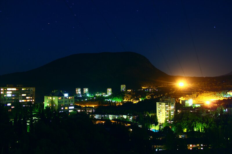 Nighttime Cityscape with Mountain