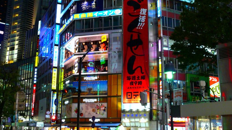 nighttime cityscape with neon signs