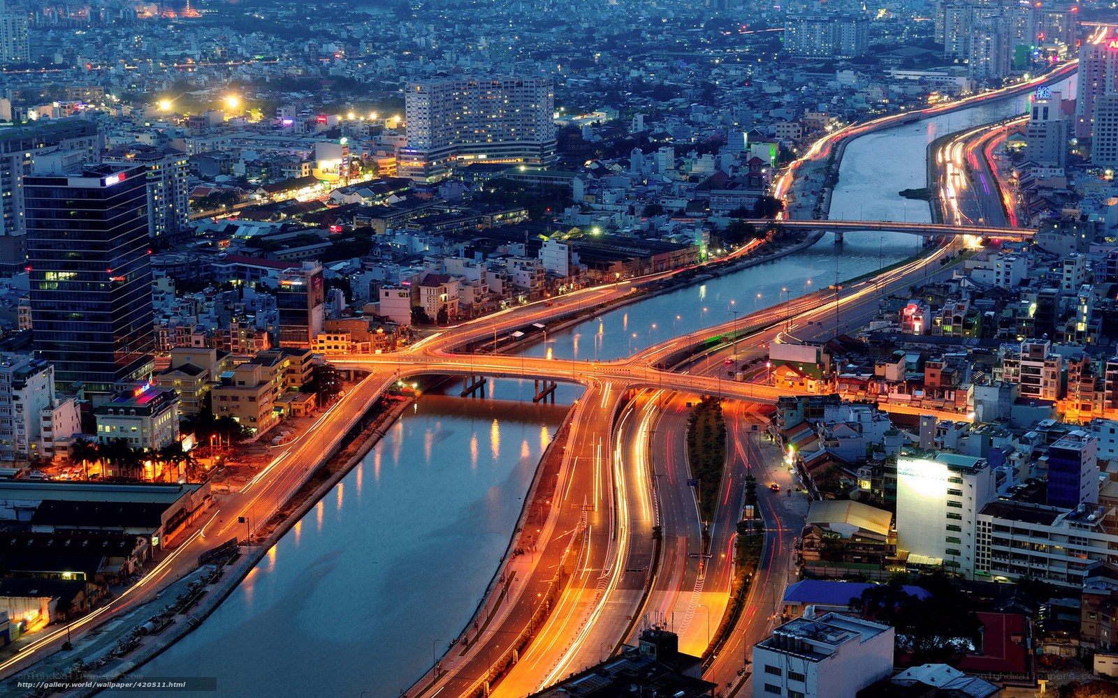 Nighttime cityscape with river and traffic