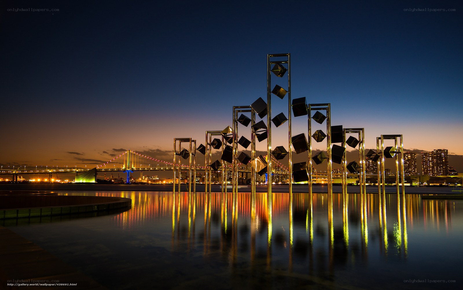 Nighttime cityscape with sculpture