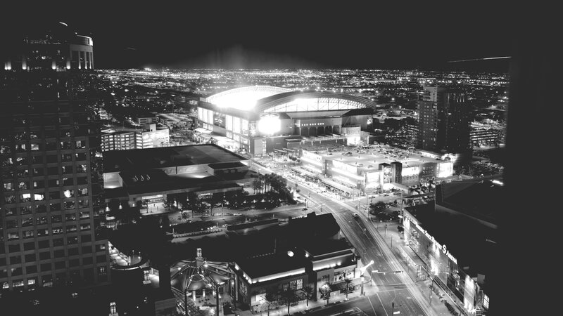 Nighttime Cityscape with Stadium
