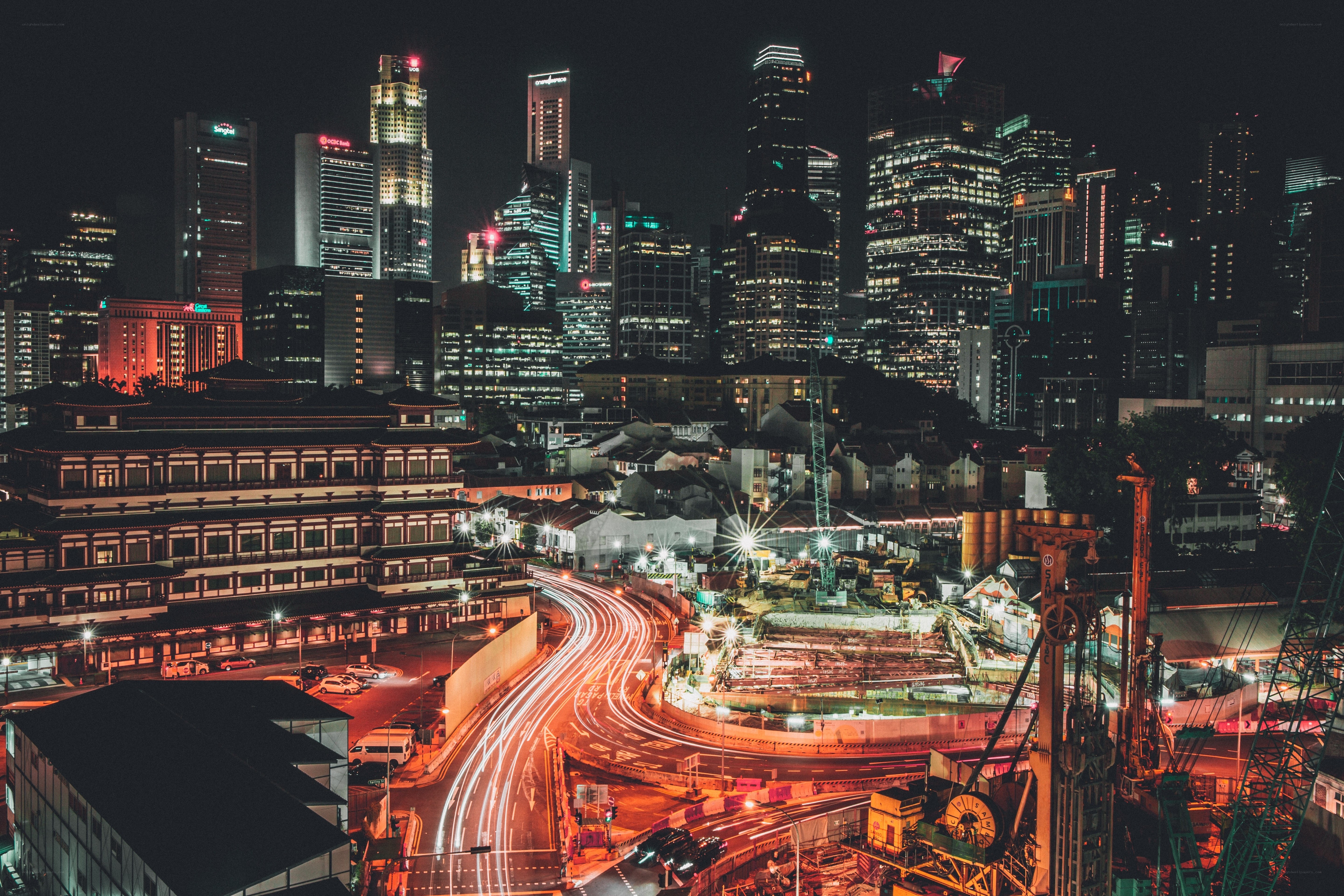 Nighttime cityscape with traffic trails