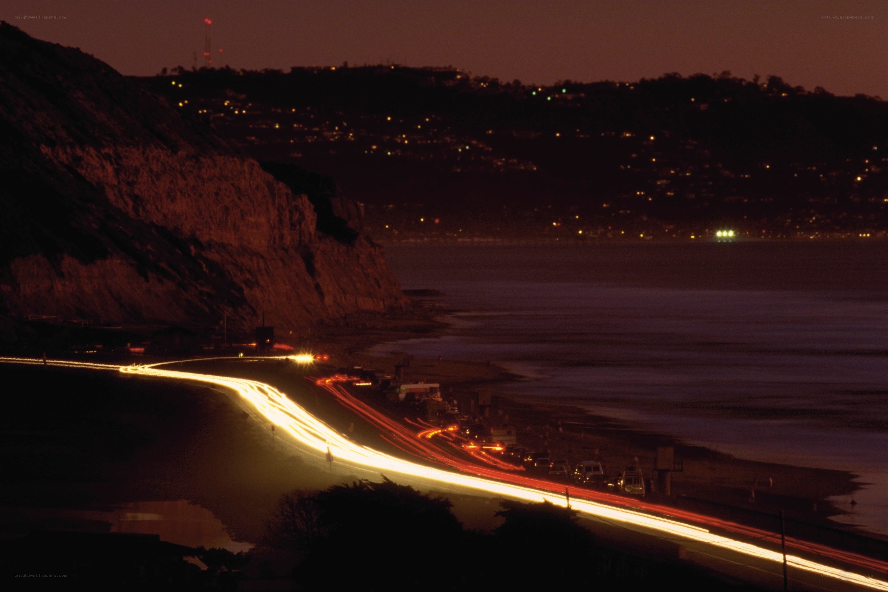 Nighttime coastal road lights