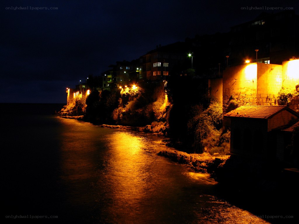 nighttime coastal town lights