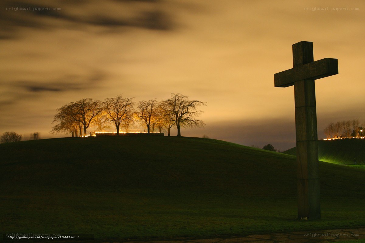 Nighttime cross on a hill