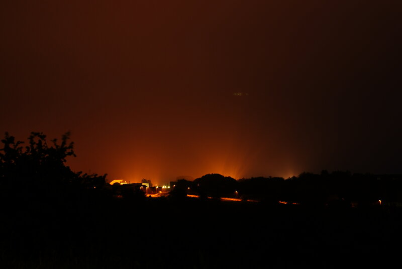 Nighttime fire glow over landscape