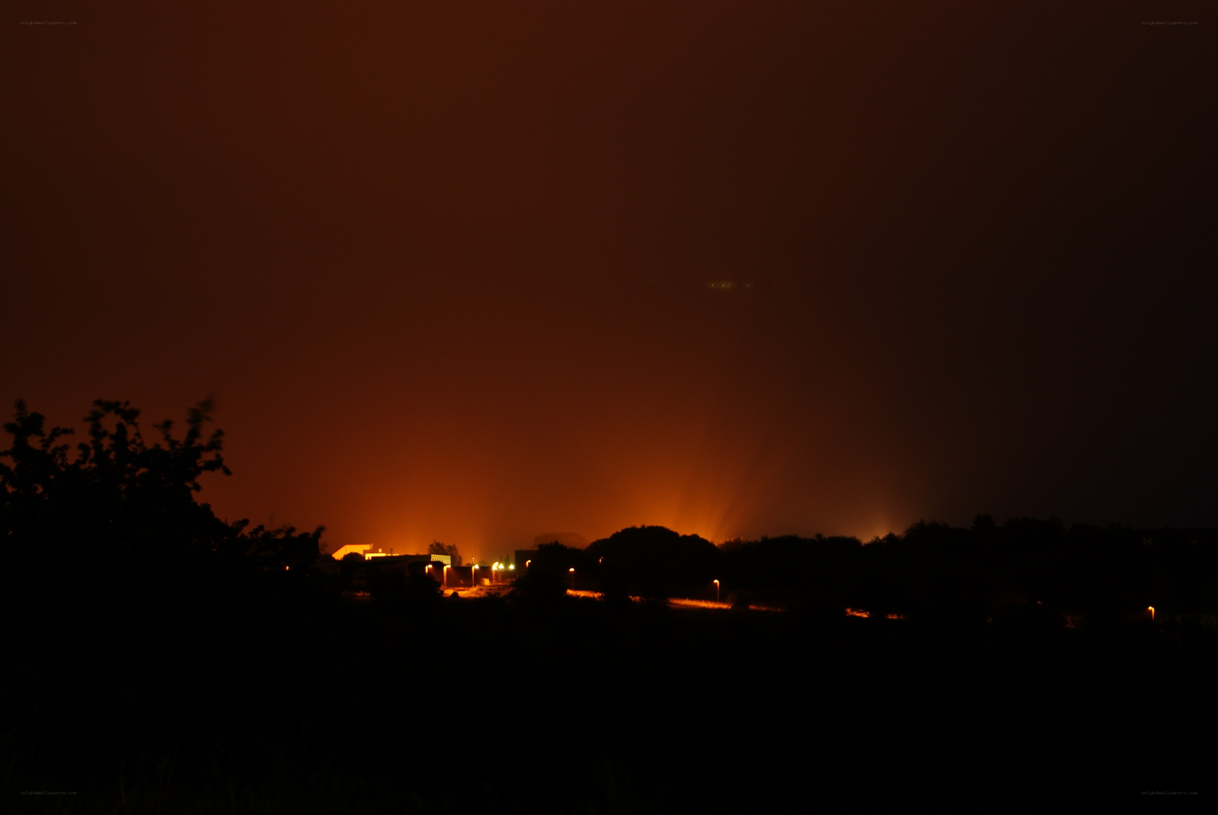Nighttime fire glow over landscape