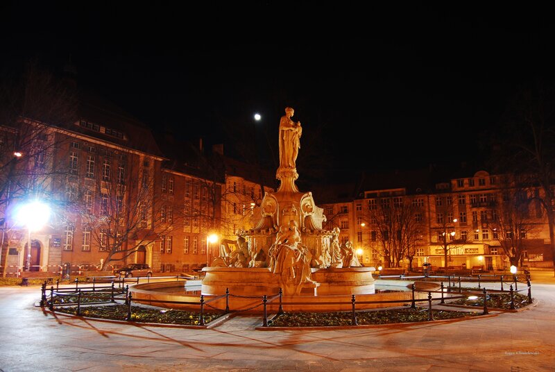nighttime fountain in city square