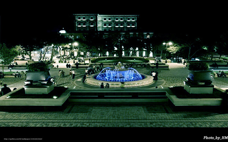 Nighttime fountain in city square
