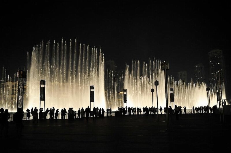 Nighttime fountain show with crowd