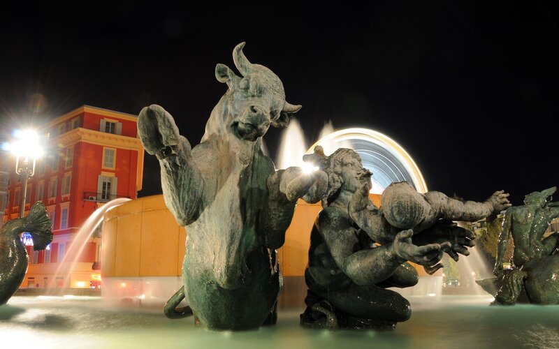 Nighttime fountain with bull sculpture