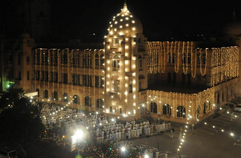 Nighttime gathering at a lit building