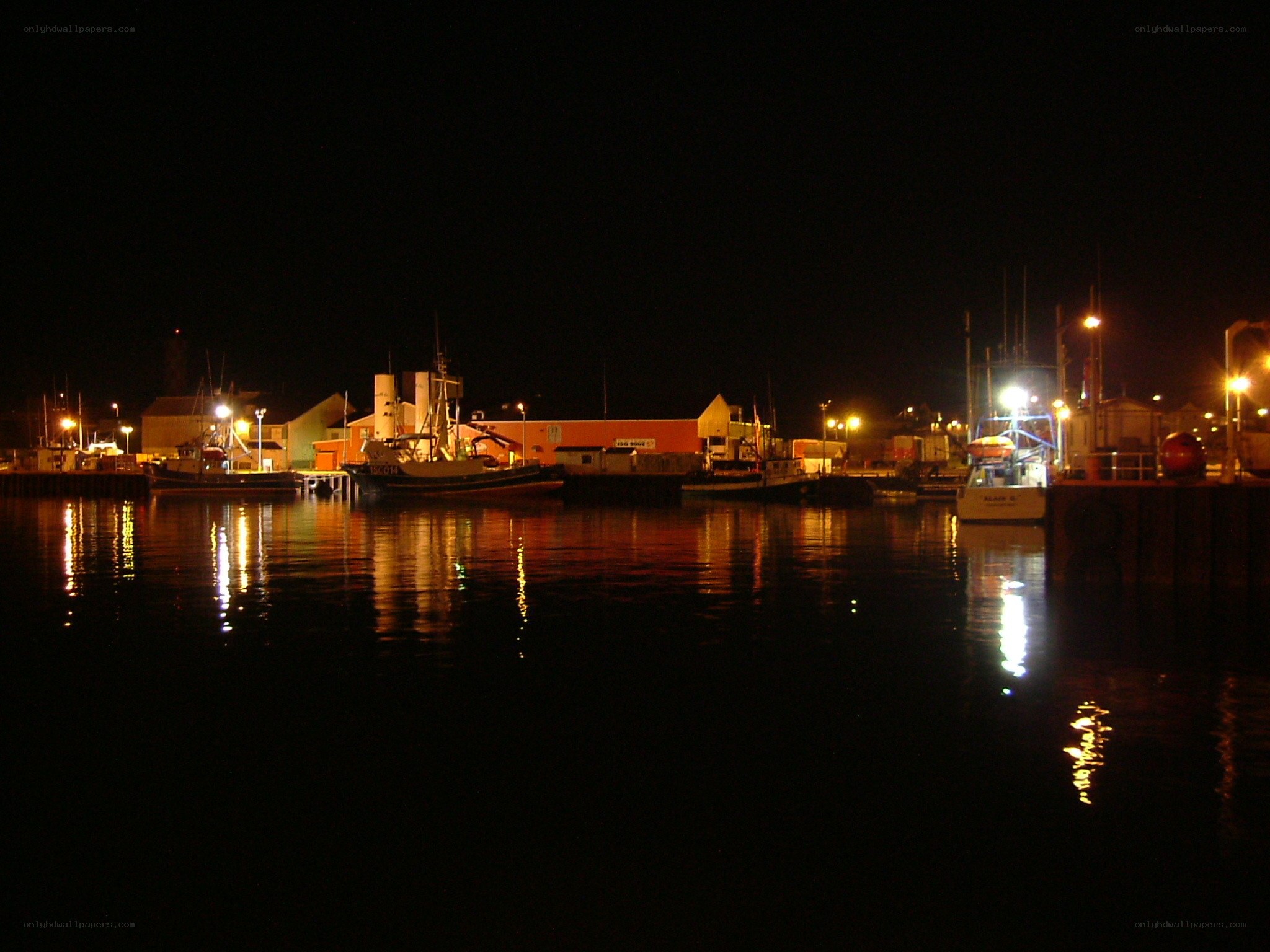 Nighttime harbor with boats