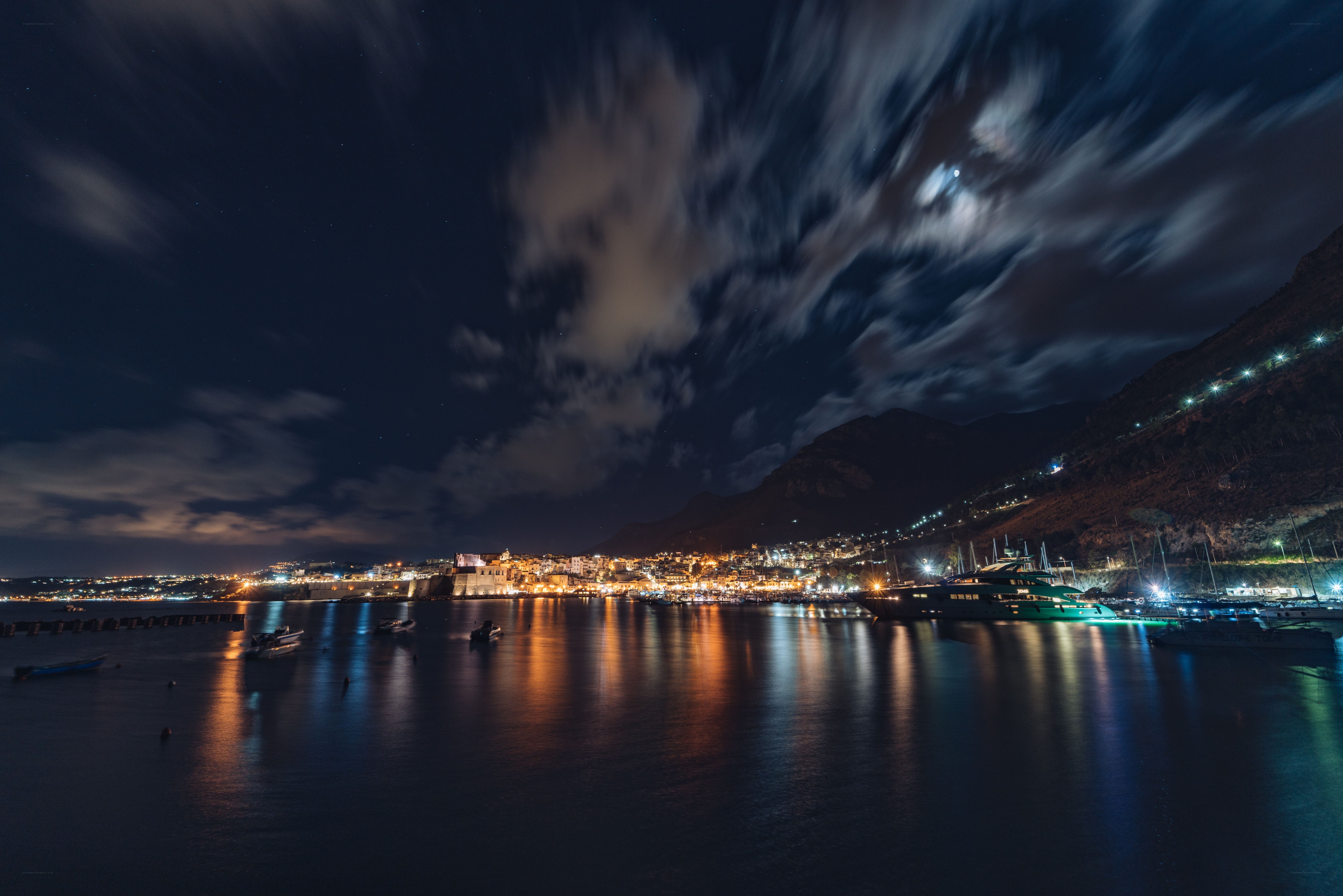 nighttime harbor with city lights