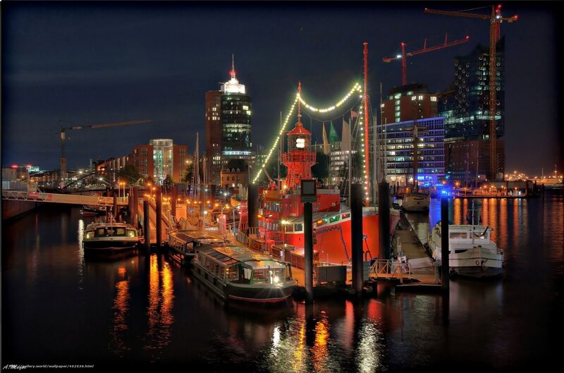Nighttime harbor with city skyline