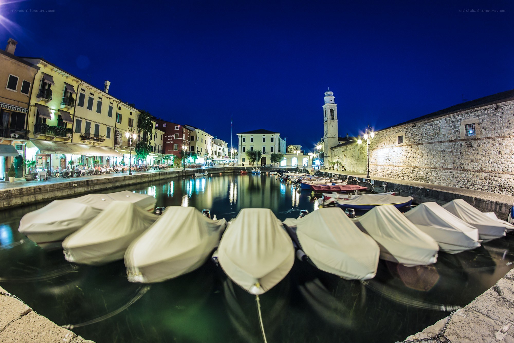 Nighttime harbor with covered boats