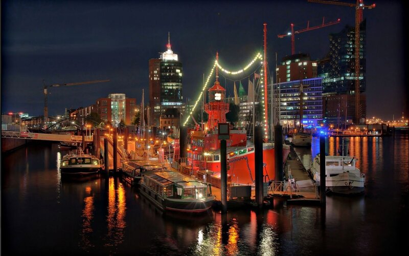 nighttime harbor with illuminated boats