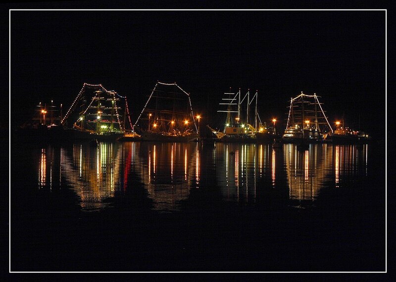 Nighttime harbor with illuminated ships