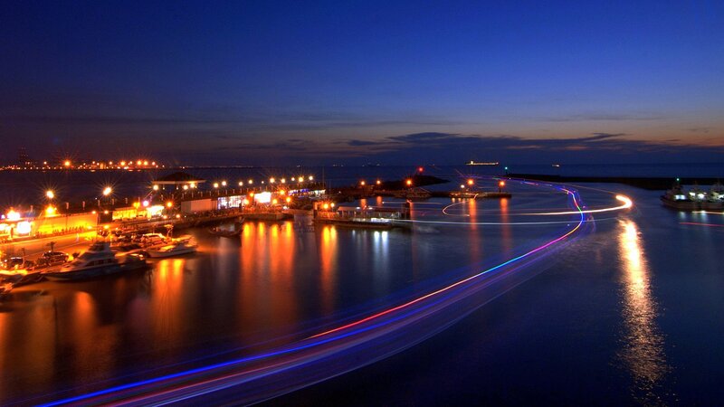 nighttime harbor with light trails