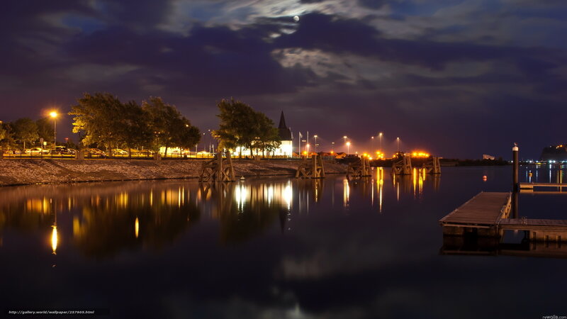 Nighttime harbor with moonlit sky