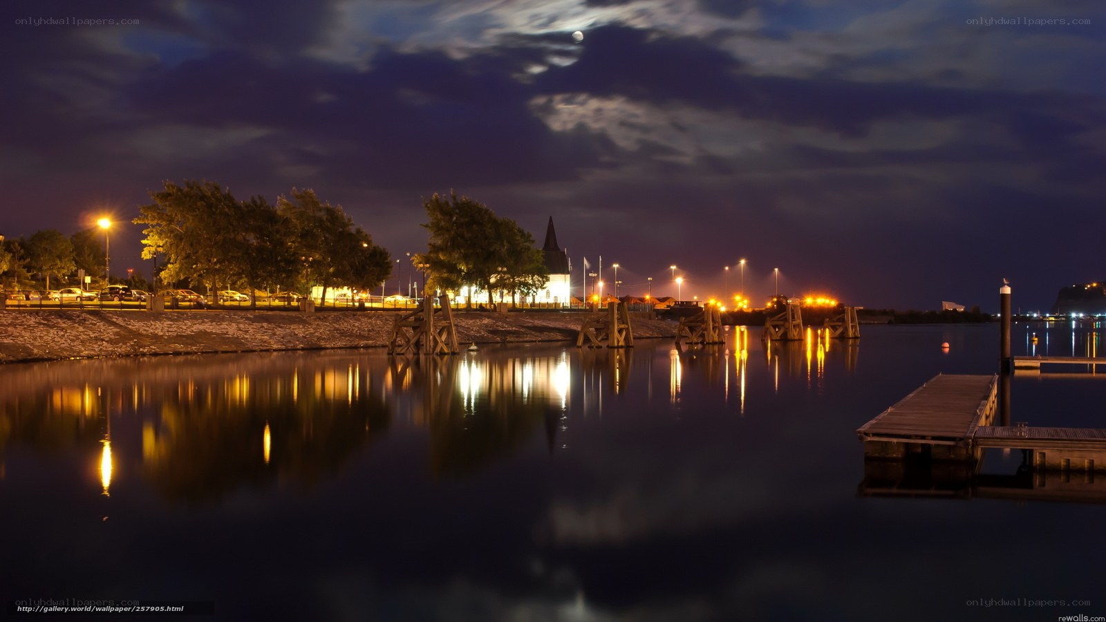 Nighttime harbor with moonlit sky