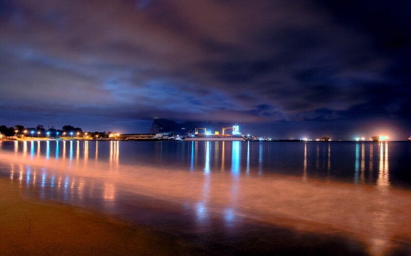 nighttime harbor with rock formation