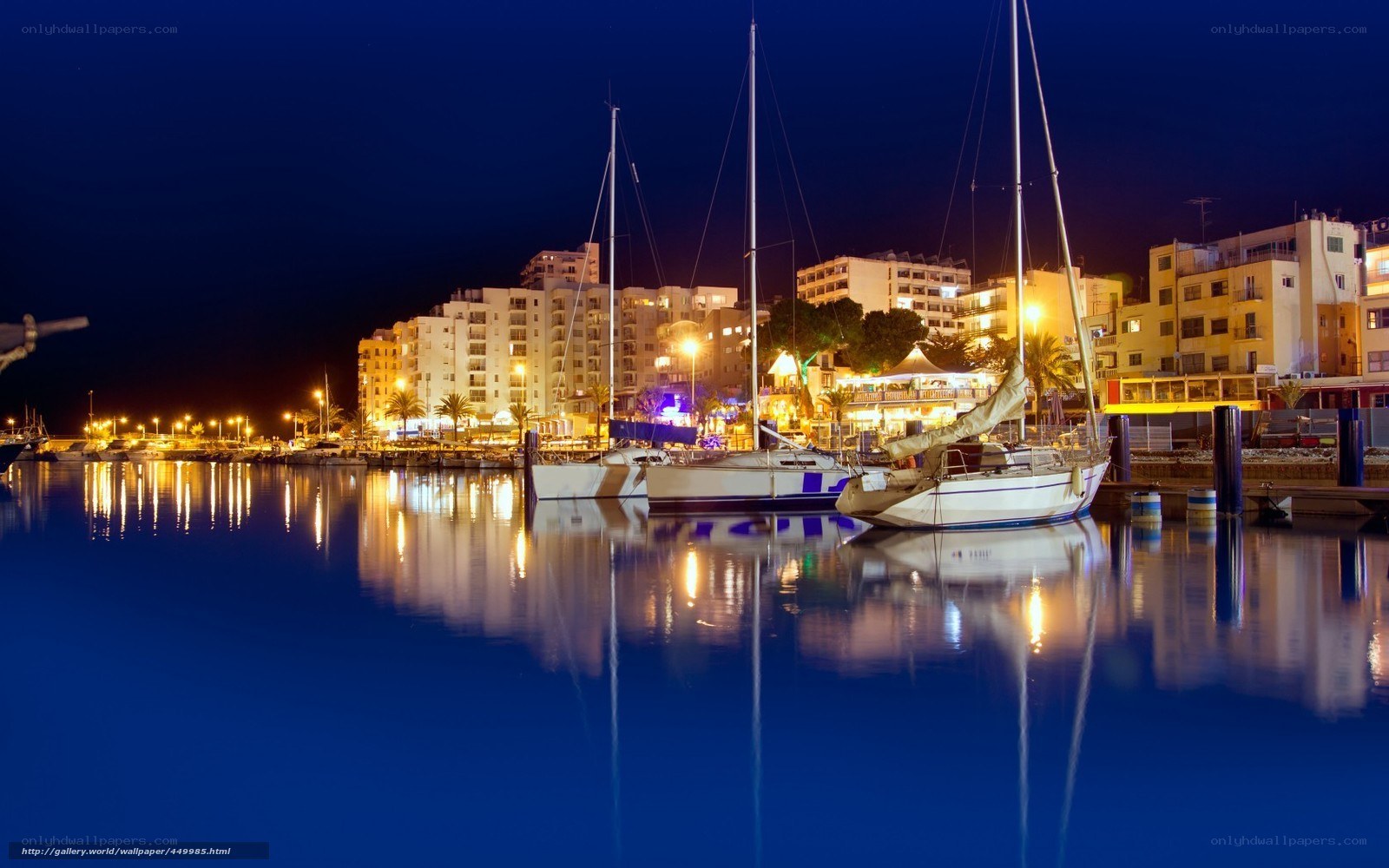 Nighttime harbor with sailboats