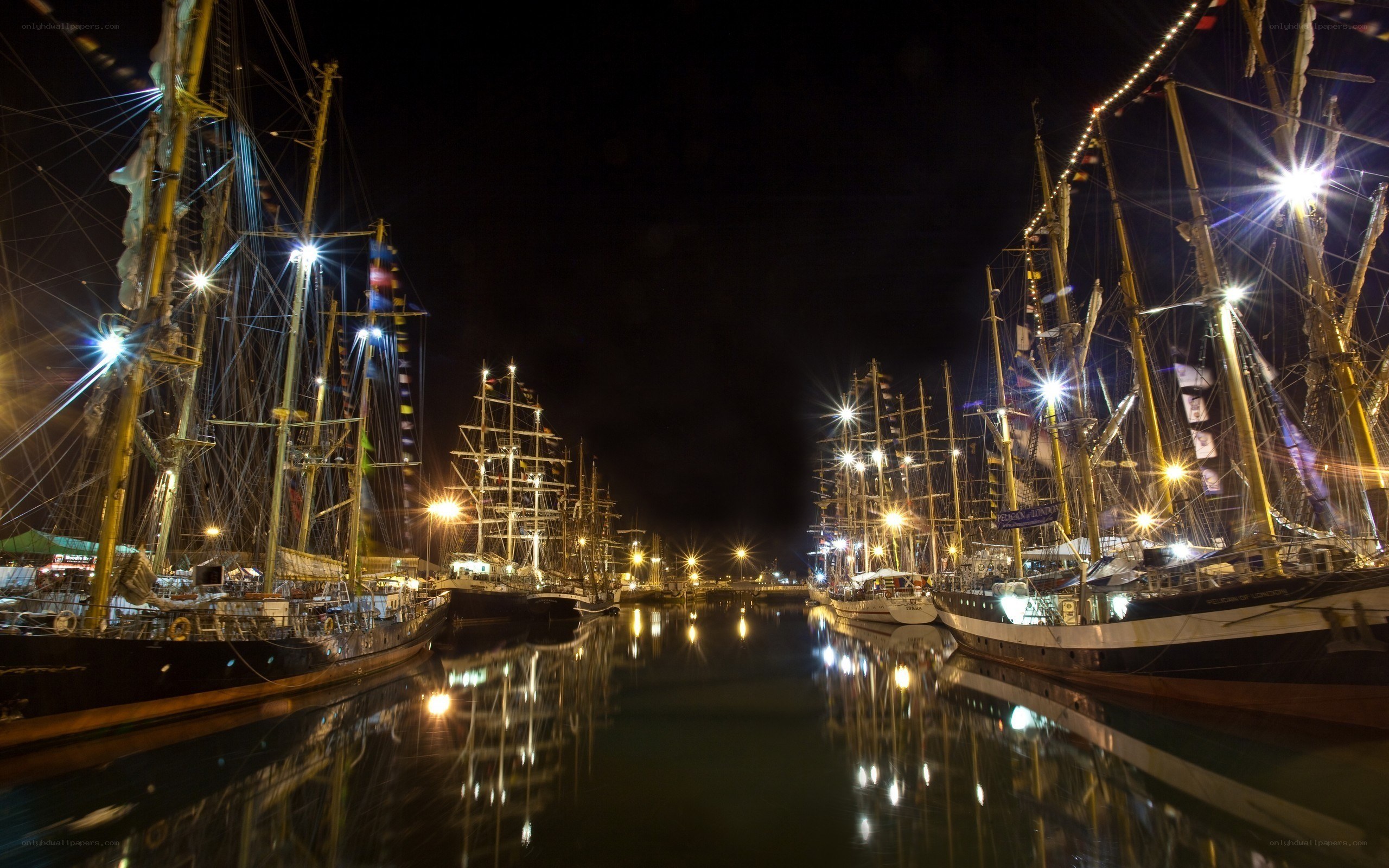 Nighttime harbor with tall ships